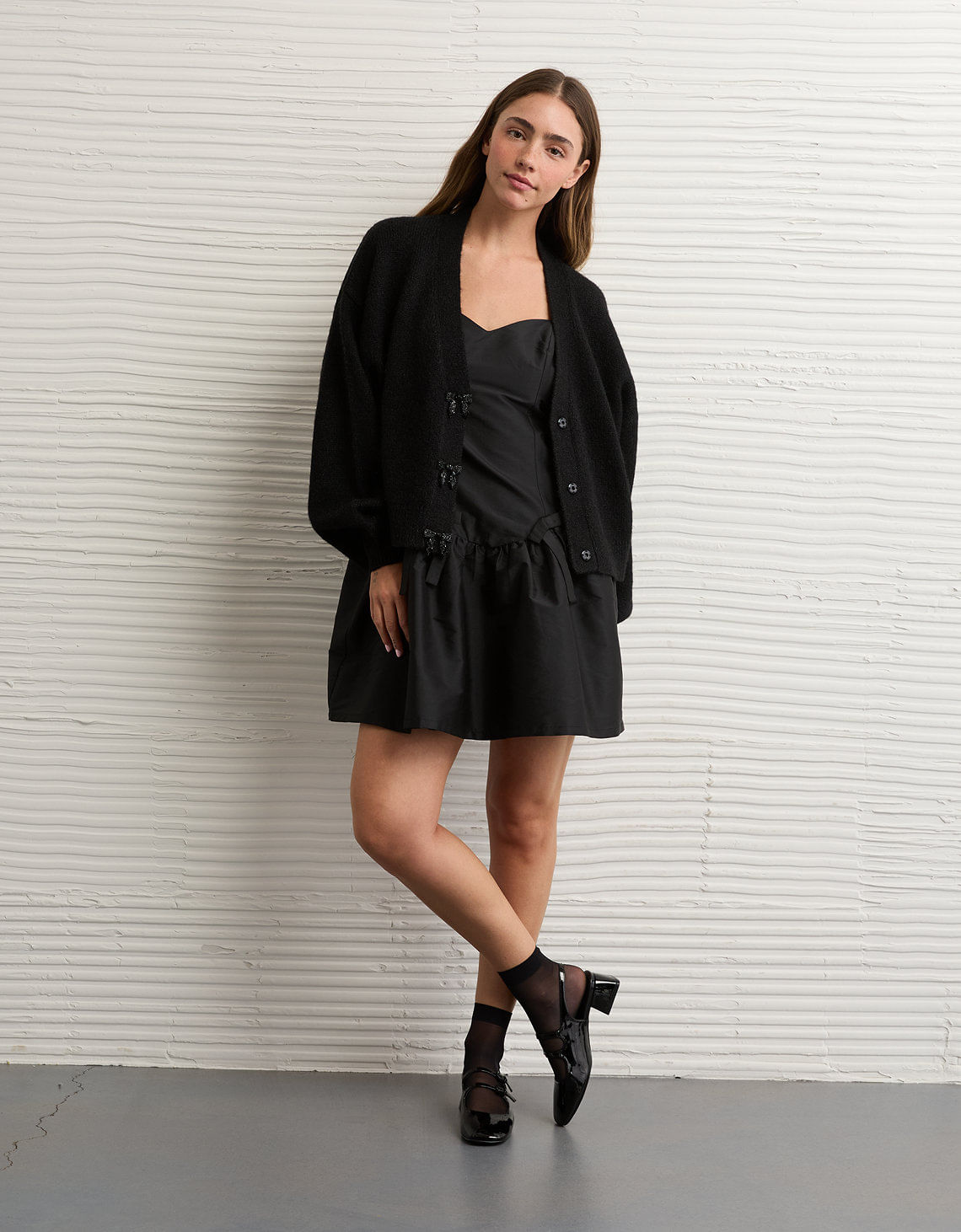 Cárdigan con cuello en V y lazo.